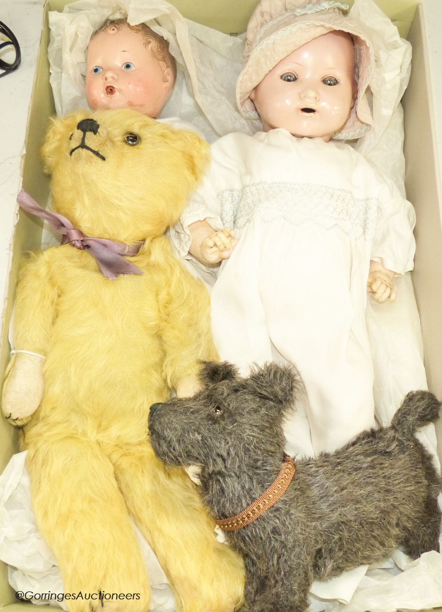 A 1939 Canadian reliable 'Netums' composition doll and a similar 'drunk-wet'doll, a gold mohair unjointed teddy bear and brown terrier